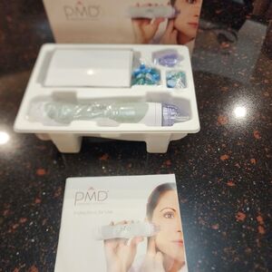 PMD Skincare Device with Blue and Purple Attachments